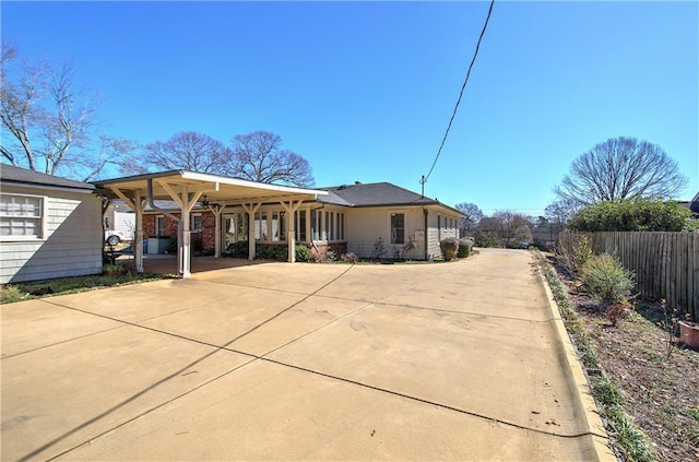 rear view of property with fence and driveway