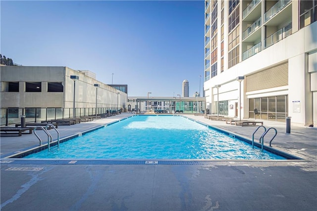 view of swimming pool featuring a patio area