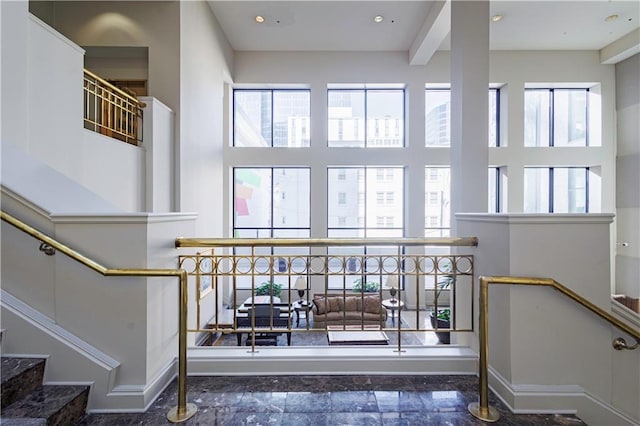 staircase featuring a towering ceiling