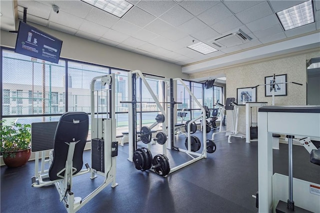 workout area with a paneled ceiling