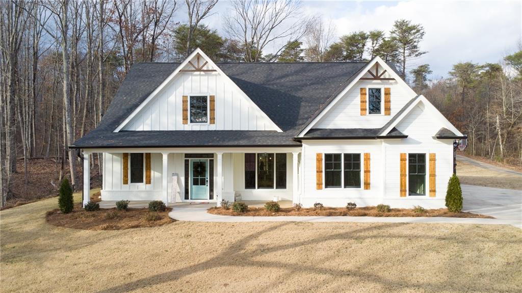 modern inspired farmhouse with a porch and a front lawn