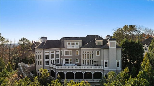 back of property featuring a balcony