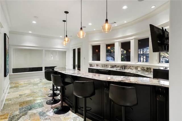 kitchen with a kitchen breakfast bar, light stone counters, crown molding, sink, and pendant lighting