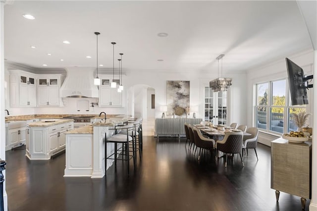 dining space with a notable chandelier, dark hardwood / wood-style floors, and ornamental molding