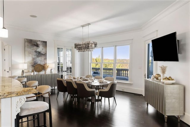 dining room with a notable chandelier, dark hardwood / wood-style floors, and crown molding