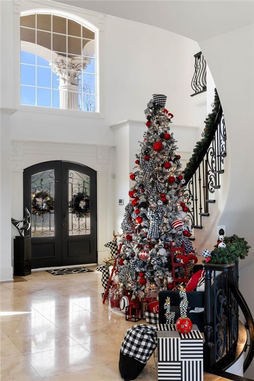 foyer with a high ceiling and french doors