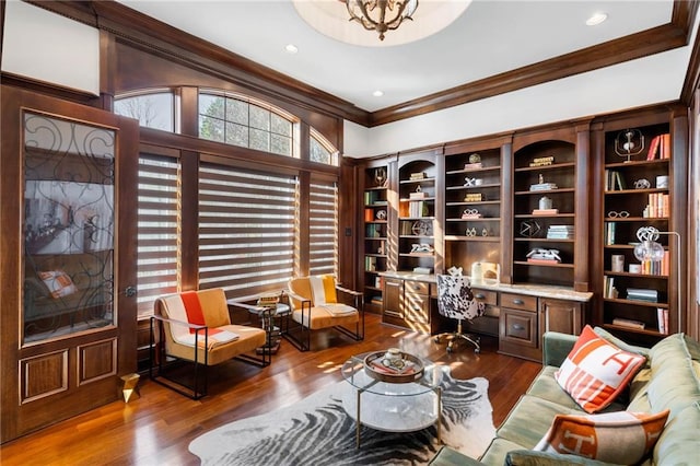 sitting room featuring dark hardwood / wood-style floors, built in desk, and ornamental molding