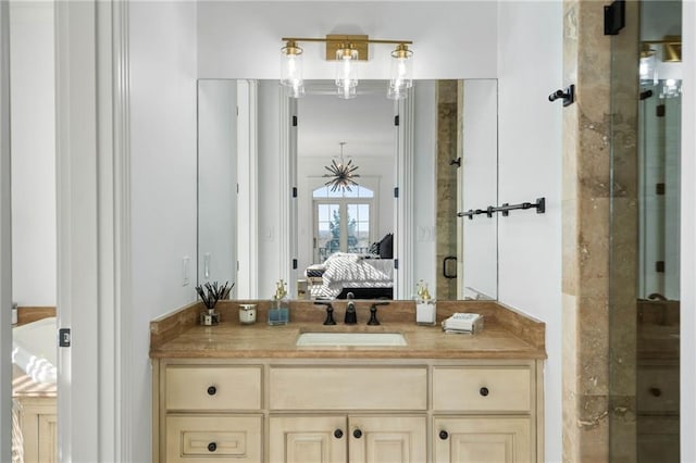 bathroom featuring french doors, vanity, and an enclosed shower