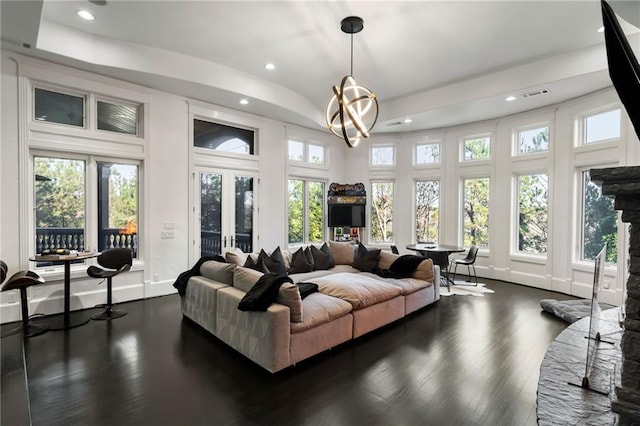 sunroom / solarium featuring an inviting chandelier