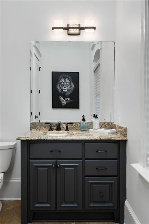 bathroom with vanity and toilet