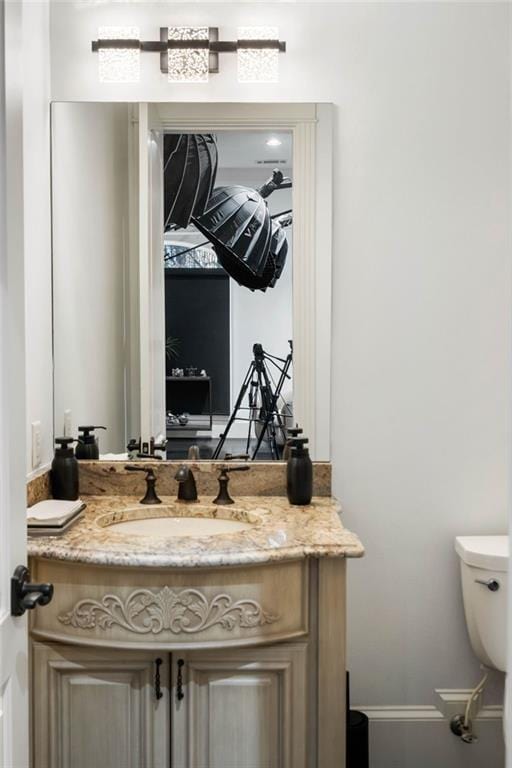 bathroom featuring vanity and toilet