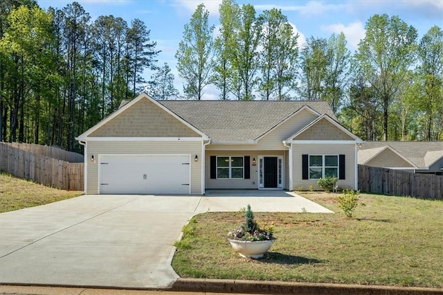 view of front facade with an attached garage, fence, and driveway