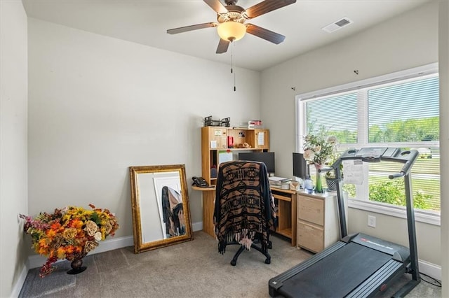 carpeted home office with visible vents, baseboards, and a ceiling fan