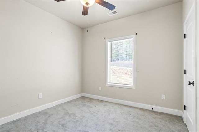 unfurnished room with a ceiling fan, baseboards, carpet, and visible vents