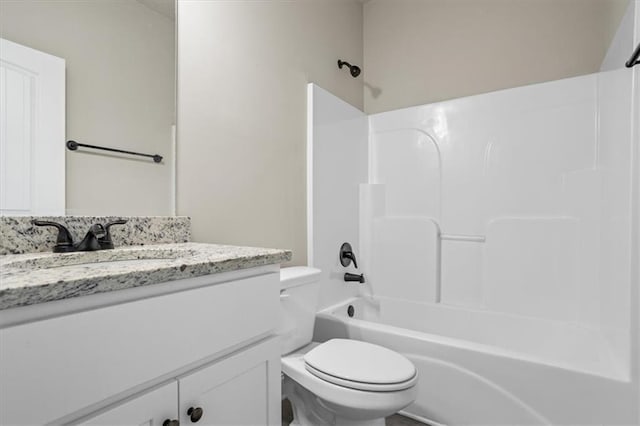 bathroom featuring toilet, shower / bathing tub combination, and vanity
