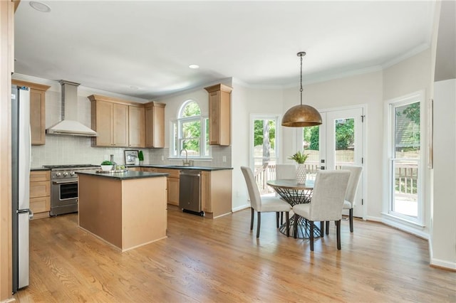 1096 Bridge Mill Ave, Canton, GA 30114 - kitchen featuring wall chimney range hood, stainless steel appliances, dark countertops, tasteful backsplash, and light wood-type flooring