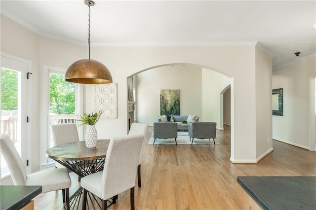1096 Bridge Mill Ave, Canton, GA 30114 - dining area with arched walkways, crown molding, light wood-style floors, and baseboards