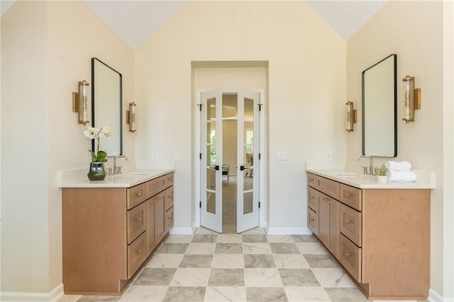 1096 Bridge Mill Ave, Canton, GA 30114 - bathroom featuring lofted ceiling, two vanities, baseboards, and french doors