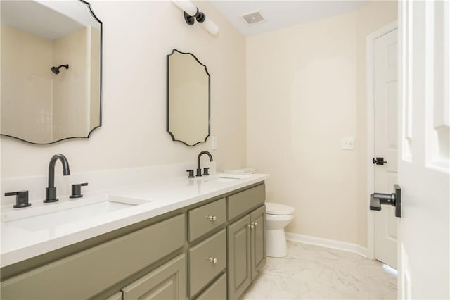 1096 Bridge Mill Ave, Canton, GA 30114 - bathroom with toilet, double vanity, marble look tiles, and baseboards