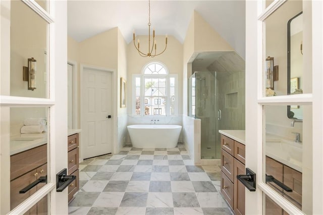 1096 Bridge Mill Ave, Canton, GA 30114 - bathroom with vanity, a soaking tub, a stall shower, vaulted ceiling, and a chandelier