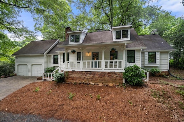1104 Warrenhall Ln NE, Brookhaven, GA 30319 - view of front of house with a porch, an attached garage, a chimney, and driveway