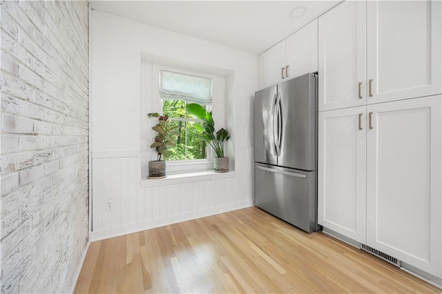 1104 Warrenhall Ln NE, Brookhaven, GA 30319 - kitchen featuring freestanding refrigerator, light wood-type flooring, white cabinetry, and wainscoting