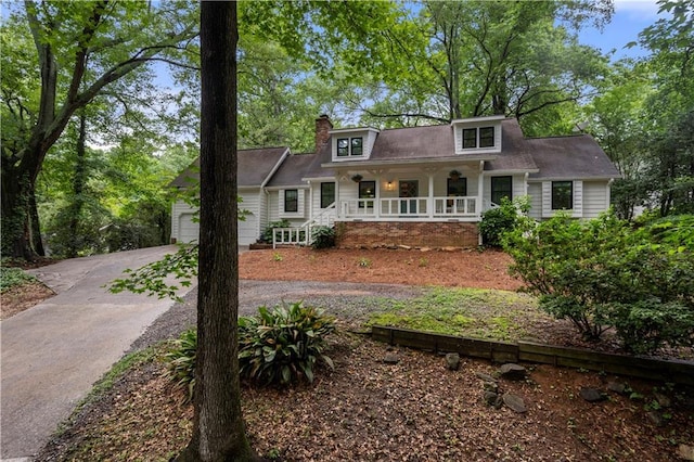 1104 Warrenhall Ln NE, Brookhaven, GA 30319 - view of front of property with covered porch, driveway, a chimney, and a garage
