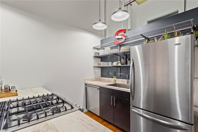 19 Hilliard St SE Unit 13, Atlanta, GA 30312 - kitchen featuring stainless steel appliances, a sink, light countertops, open shelves, and light wood finished floors