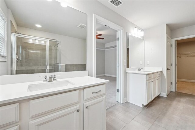 791 Belrose Dr, Smyrna, GA 30080 - bathroom with a ceiling fan, a shower stall, two vanities, a walk in closet, and tile patterned floors