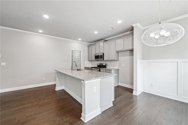 kitchen with gray cabinets, appliances with stainless steel finishes, dark wood-type flooring, ornamental molding, and a sink