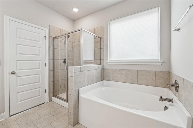 full bath with a stall shower, a bath, and tile patterned floors