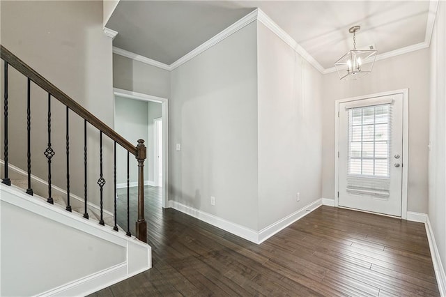 entryway featuring hardwood / wood-style flooring, stairs, baseboards, and crown molding