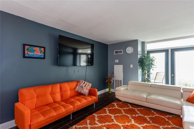 living area featuring baseboards and wood finish floors