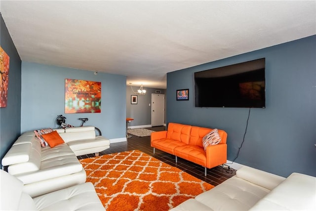 living room with wood finished floors, baseboards, and a chandelier