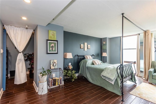 bedroom with wood finish floors, recessed lighting, and baseboards