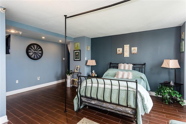 bedroom featuring baseboards, wood tiled floors, and recessed lighting