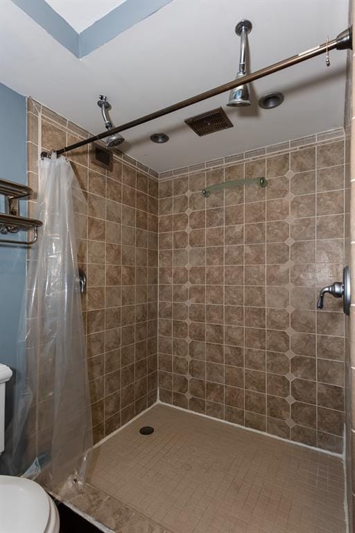 bathroom with a stall shower and toilet