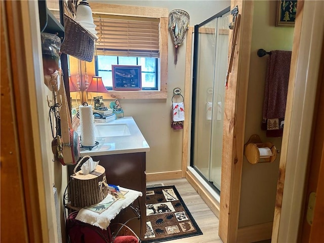 226 Hawk Hill Ln, Lakemont, GA 30552 - full bathroom featuring a stall shower, vanity, wood finished floors, and baseboards