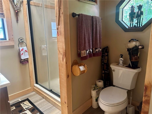 226 Hawk Hill Ln, Lakemont, GA 30552 - full bathroom with wood finished floors, a stall shower, and toilet