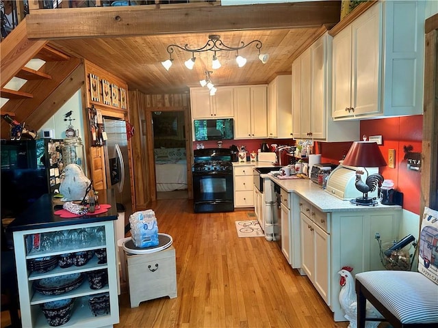 226 Hawk Hill Ln, Lakemont, GA 30552 - kitchen featuring black appliances, light wood finished floors, wooden ceiling, white cabinetry, and light countertops