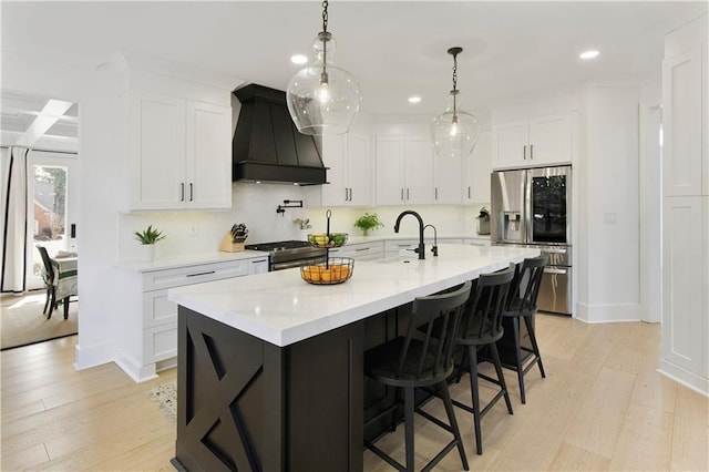 kitchen featuring stainless steel appliances, light wood-type flooring, custom exhaust hood, and light countertops