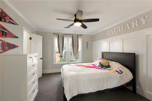 bedroom featuring baseboards, ornamental molding, dark carpet, and a ceiling fan