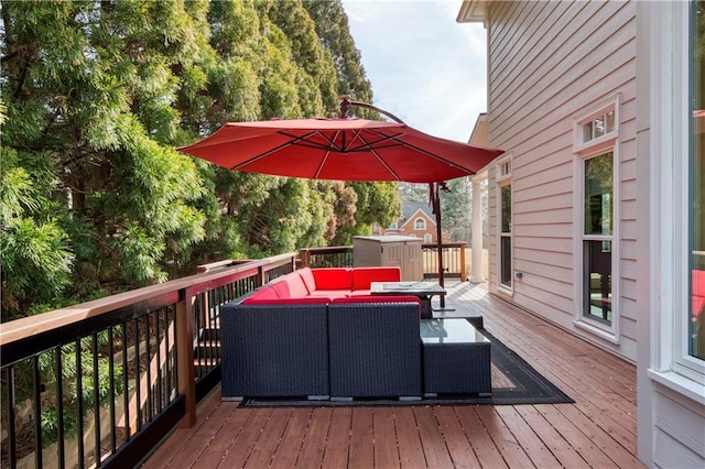 wooden terrace with an outdoor living space