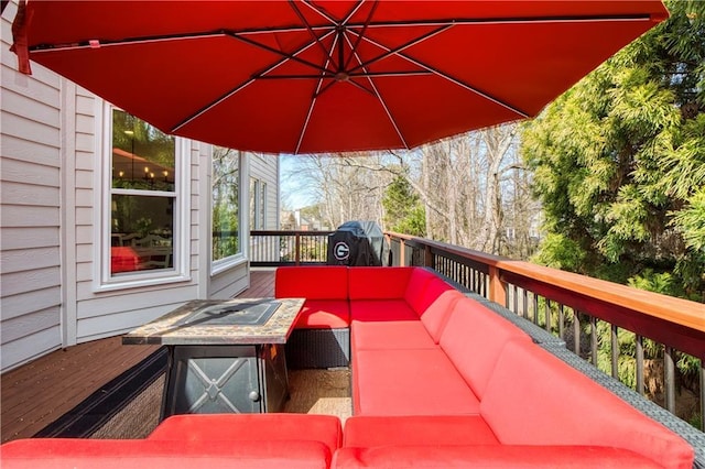 wooden terrace featuring a grill and an outdoor hangout area