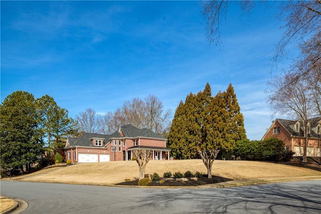 view of front of house featuring a front yard and concrete driveway