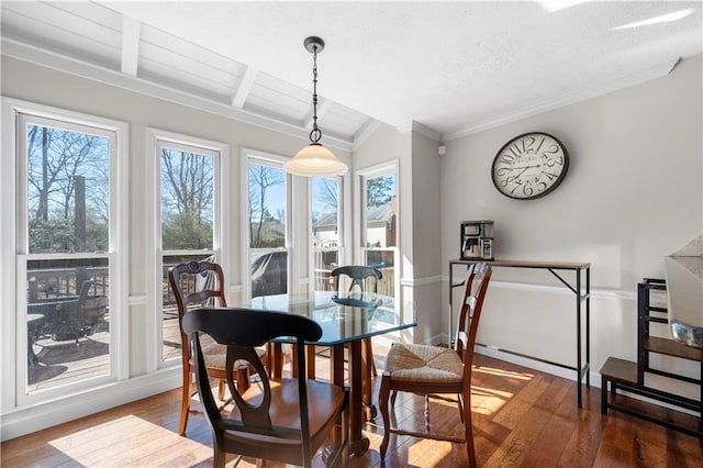 dining space featuring a textured ceiling, beam ceiling, hardwood / wood-style flooring, and crown molding