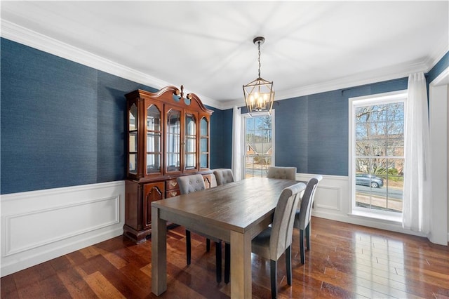 dining area featuring dark wood-style floors, a wainscoted wall, and wallpapered walls