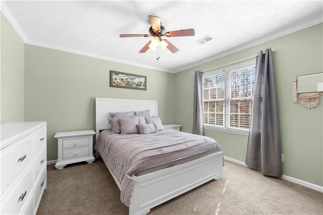 bedroom featuring carpet floors, a ceiling fan, visible vents, baseboards, and ornamental molding