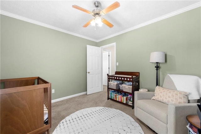 carpeted bedroom featuring ceiling fan, baseboards, and crown molding