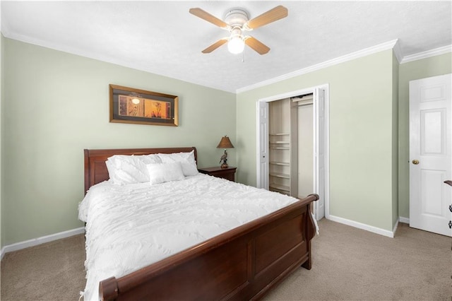 bedroom featuring ceiling fan, light colored carpet, baseboards, a closet, and crown molding